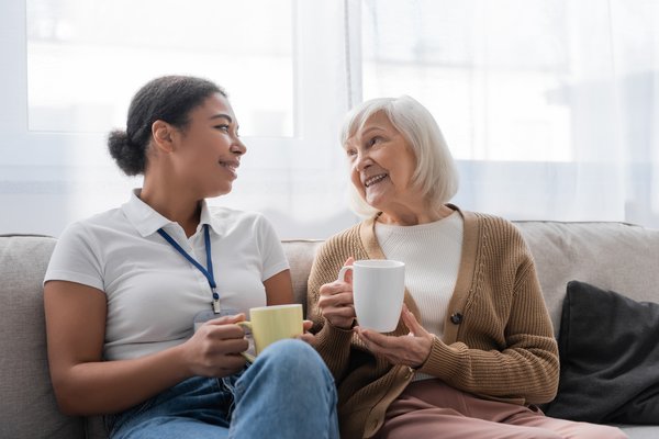 assisted-living-caregiver-elderly-woman-drinking-coffee