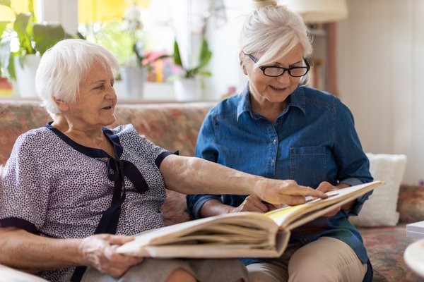 memory-care-senior-women-reading-photo-album