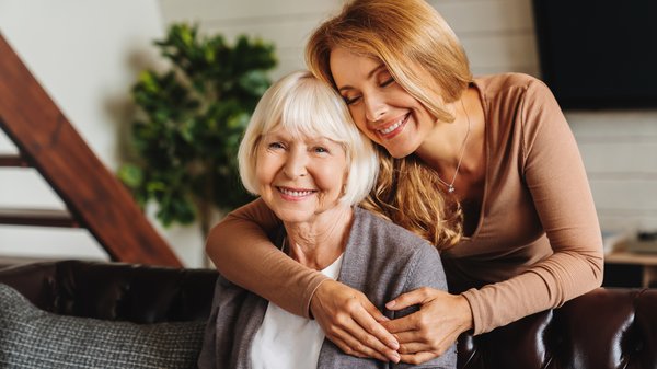 memory-care-young-woman-hugging-elderly-mother-1