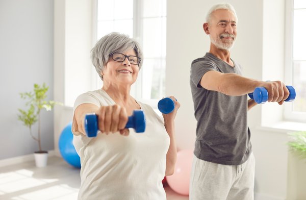 activities-senior-couple-exercising-dumbbells-home